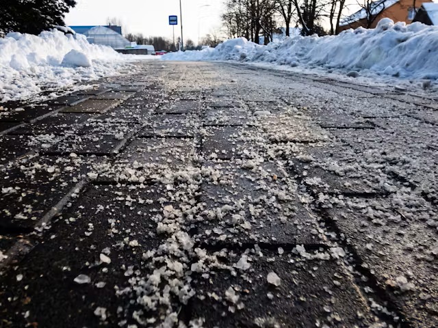 Icy Paver Path with Deicing Salt and Snowbanks