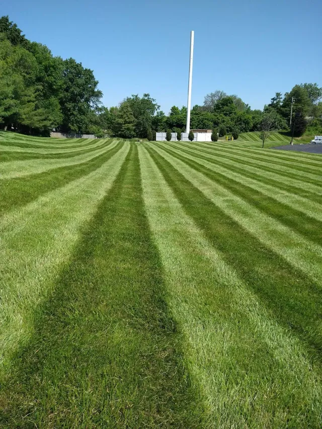 Expansive green lawn with perfectly mowed striping patterns in Hudson