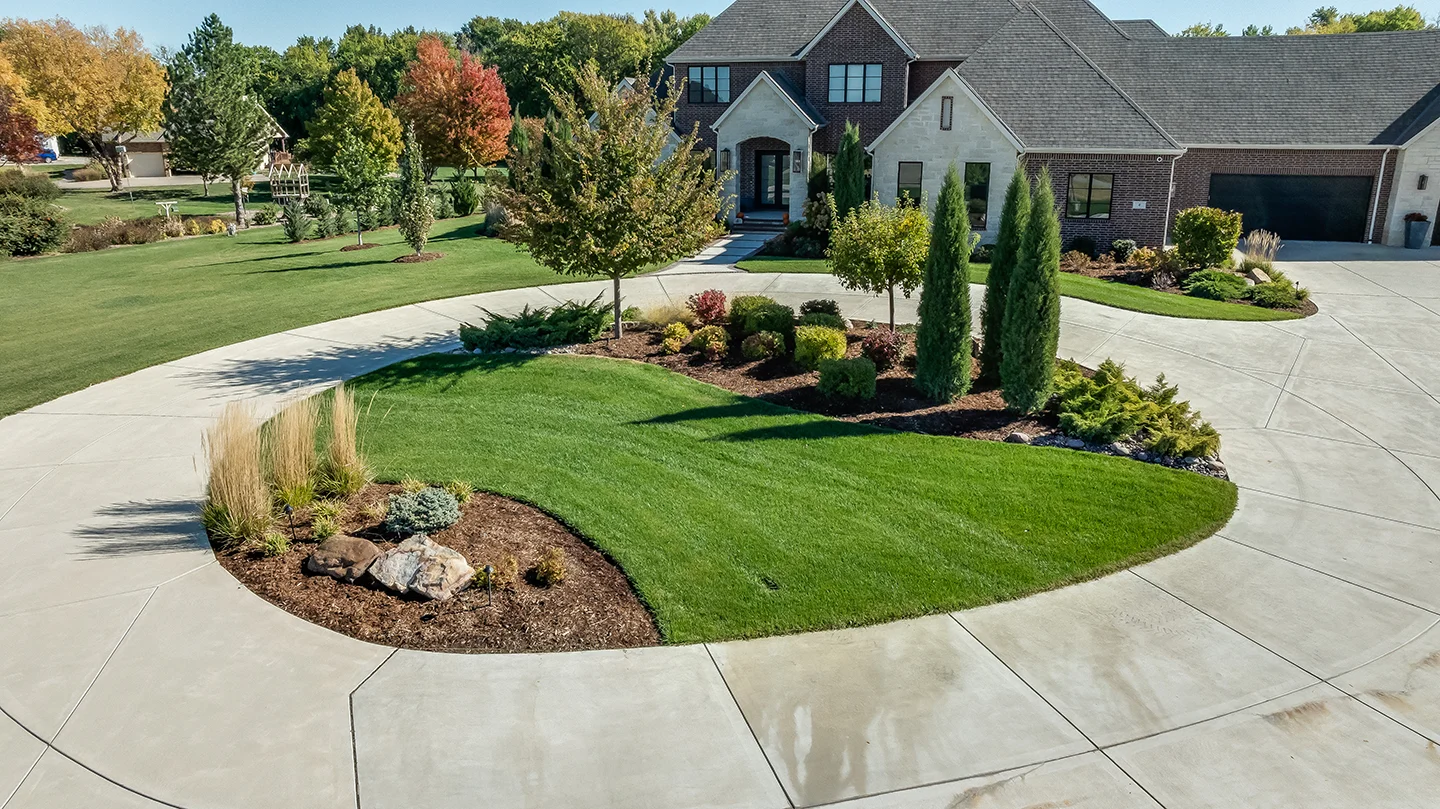 Aerial view of a circular driveway in front of a large home